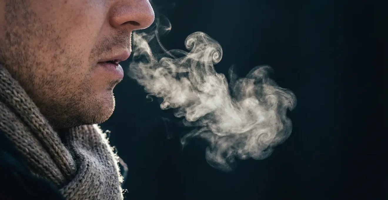Close-up of person practicing controlled breathing with visible breath vapor in cold air