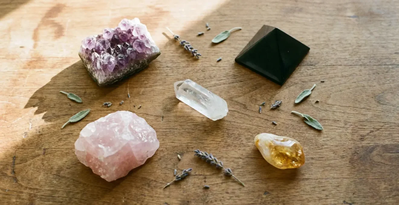 Natural arrangement of healing crystals including amethyst, rose quartz, clear quartz, shungite and citrine on neutral wooden surface for holistic wellness